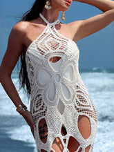 Model wearing sheer halter neck cover-up over swimwear