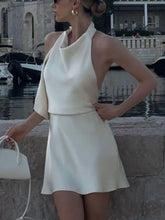 Beige halter neck mini dress from D'Journé Fashion, model wearing front view