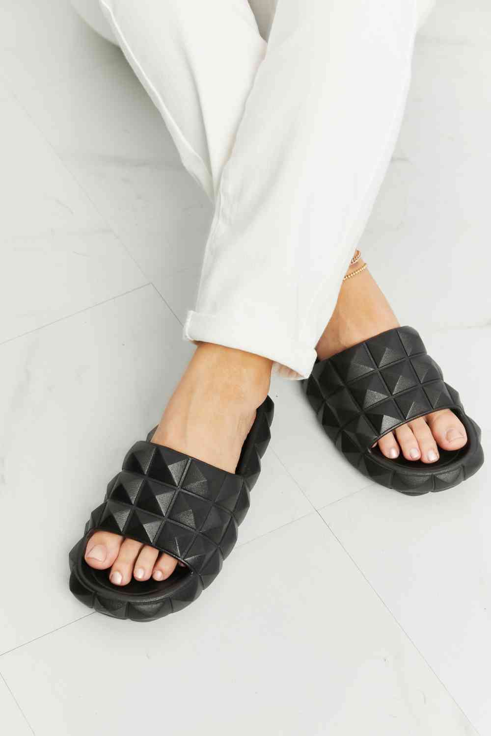 D'Journé Fashion Let's Chill 3D stud slide sandal in black, side view
