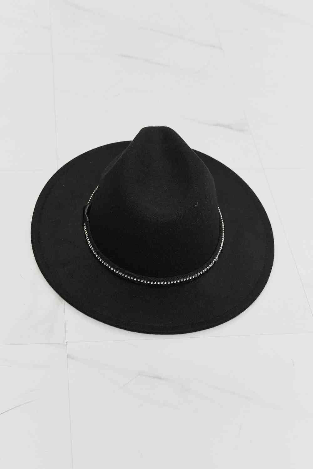 Model wearing black wide brim fedora hat