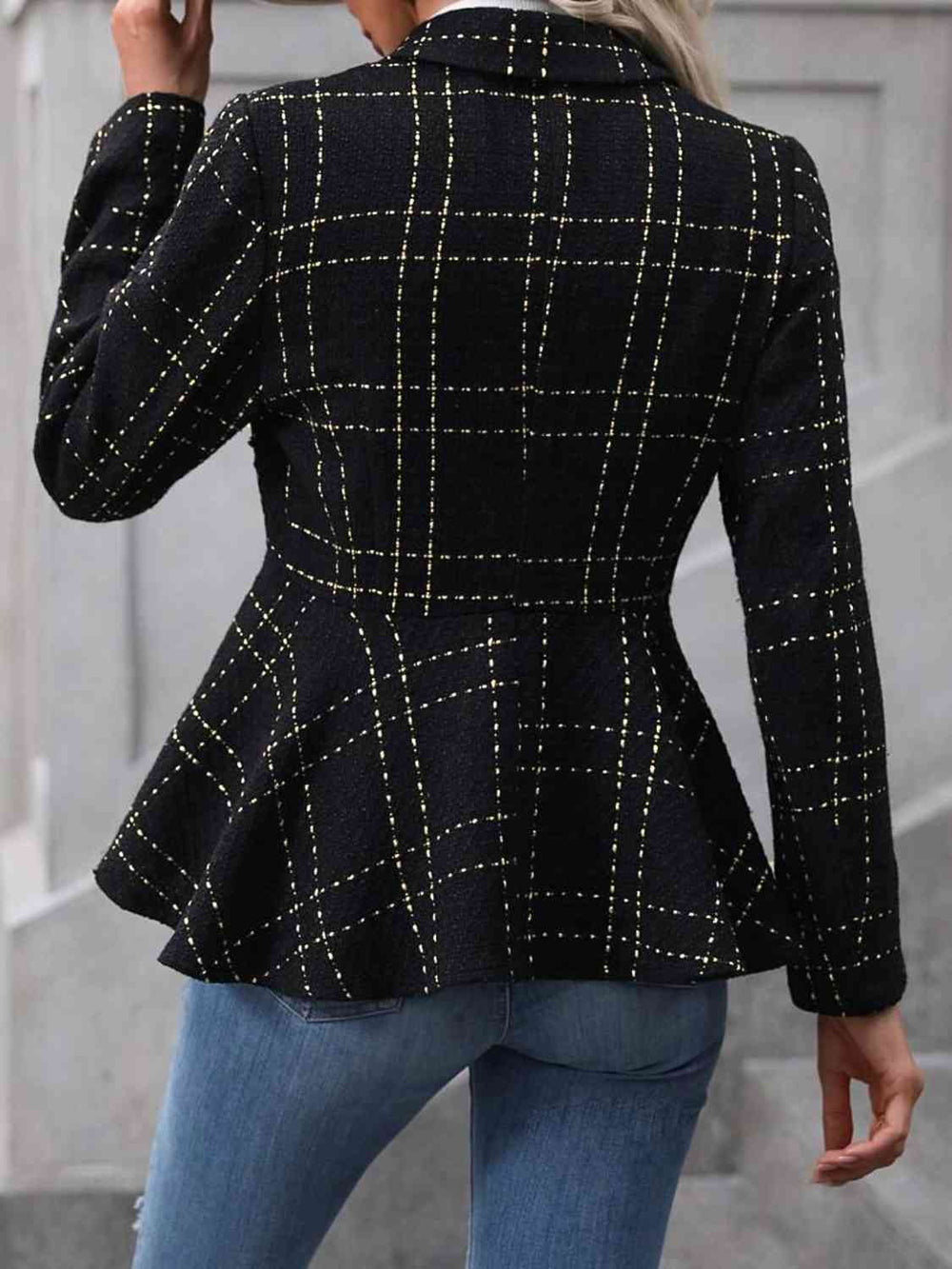 Black collared blazer, back view showing ruffle hem