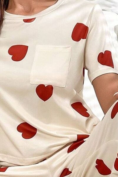 Model wearing white heart print pajama lounge set, full length view