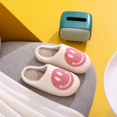 Pink smiley slippers plush faux fur texture close up