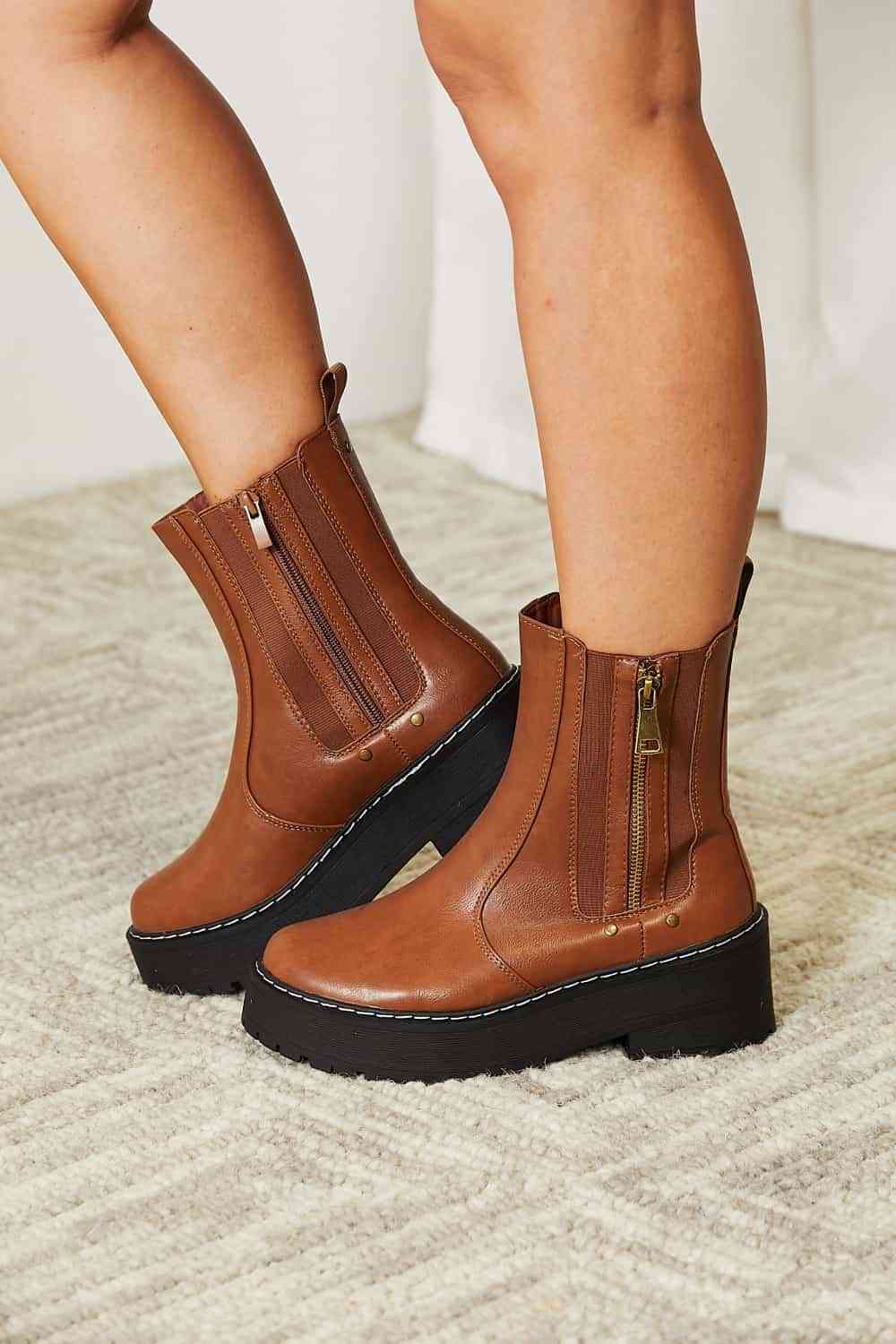 Model wearing chestnut side zip platform boots