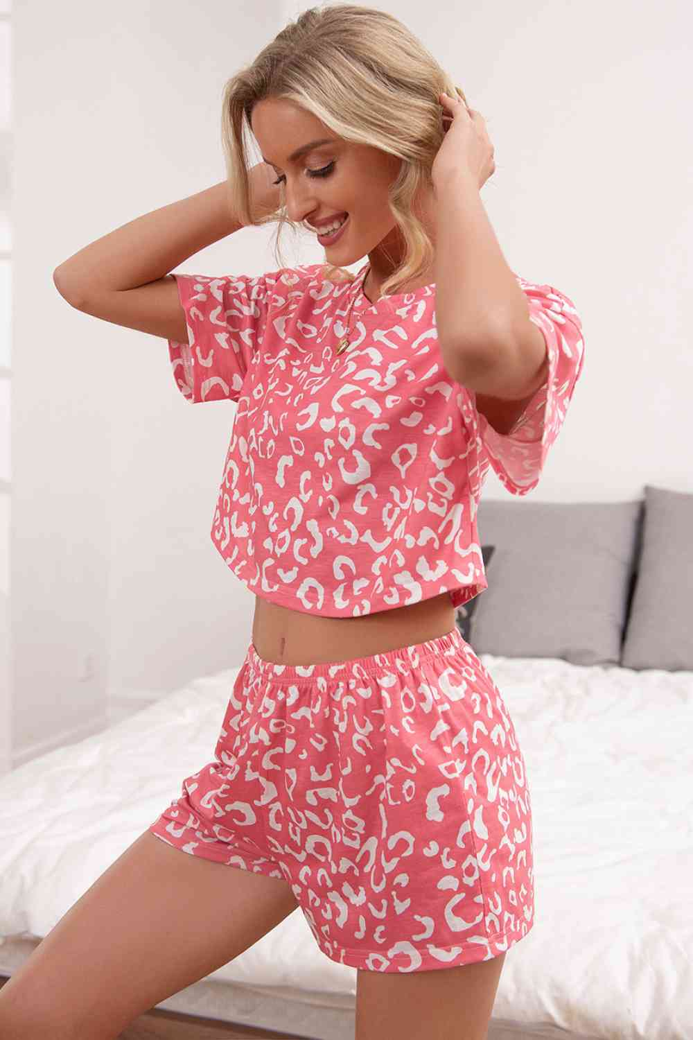 Pink leopard print crop top and shorts, model side view