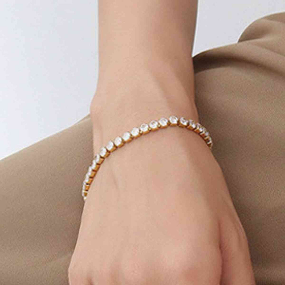 Gold titanium steel bracelet on wrist, model wearing